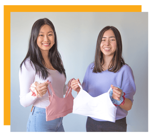 A photo of two girls holding sports bras